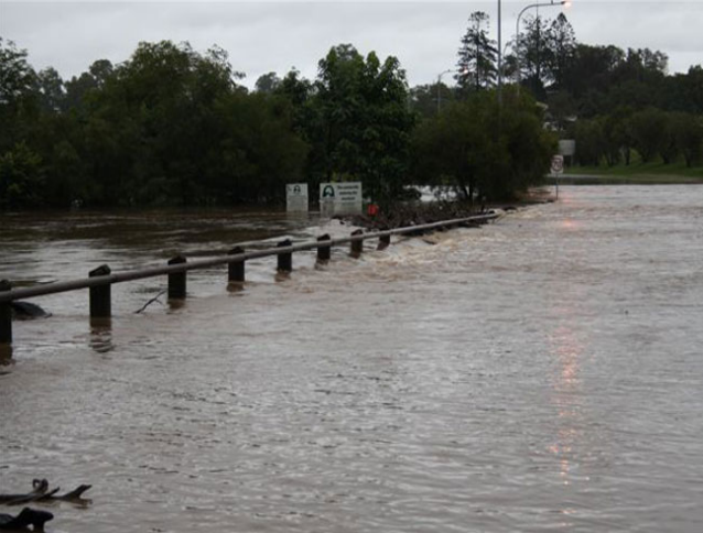 The Mary River floods across the Kidd Bridge at Gympie where the river height was 11m and was expected to peak at 14m. Picture-Ian 
Dickenson